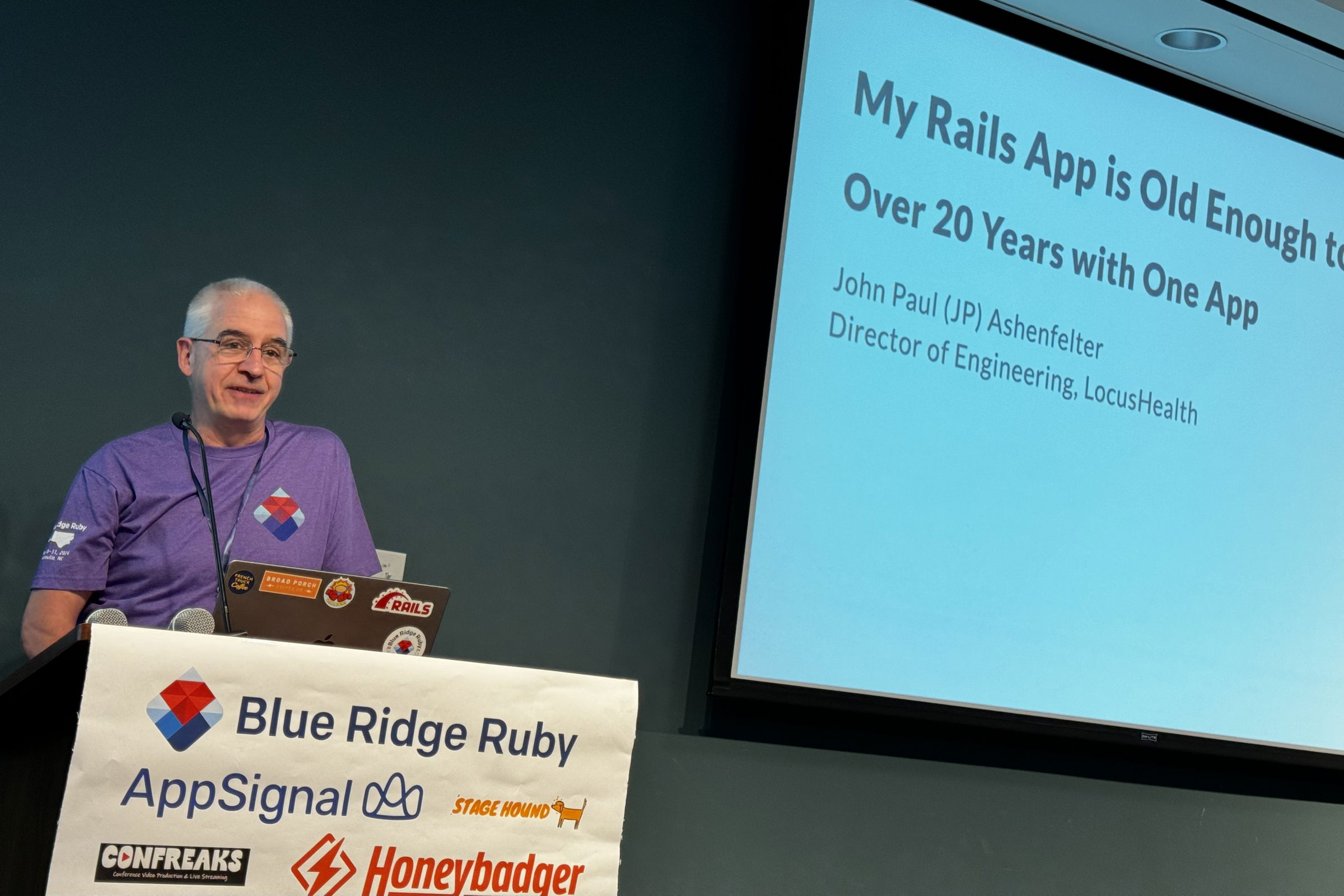 John Paul Ashenfelter at Blue Ridge Ruby conference discussing his long-term experience with a Rails application, titled “My Rails App is Old Enough to Drink: Over 20 Years with One App.”