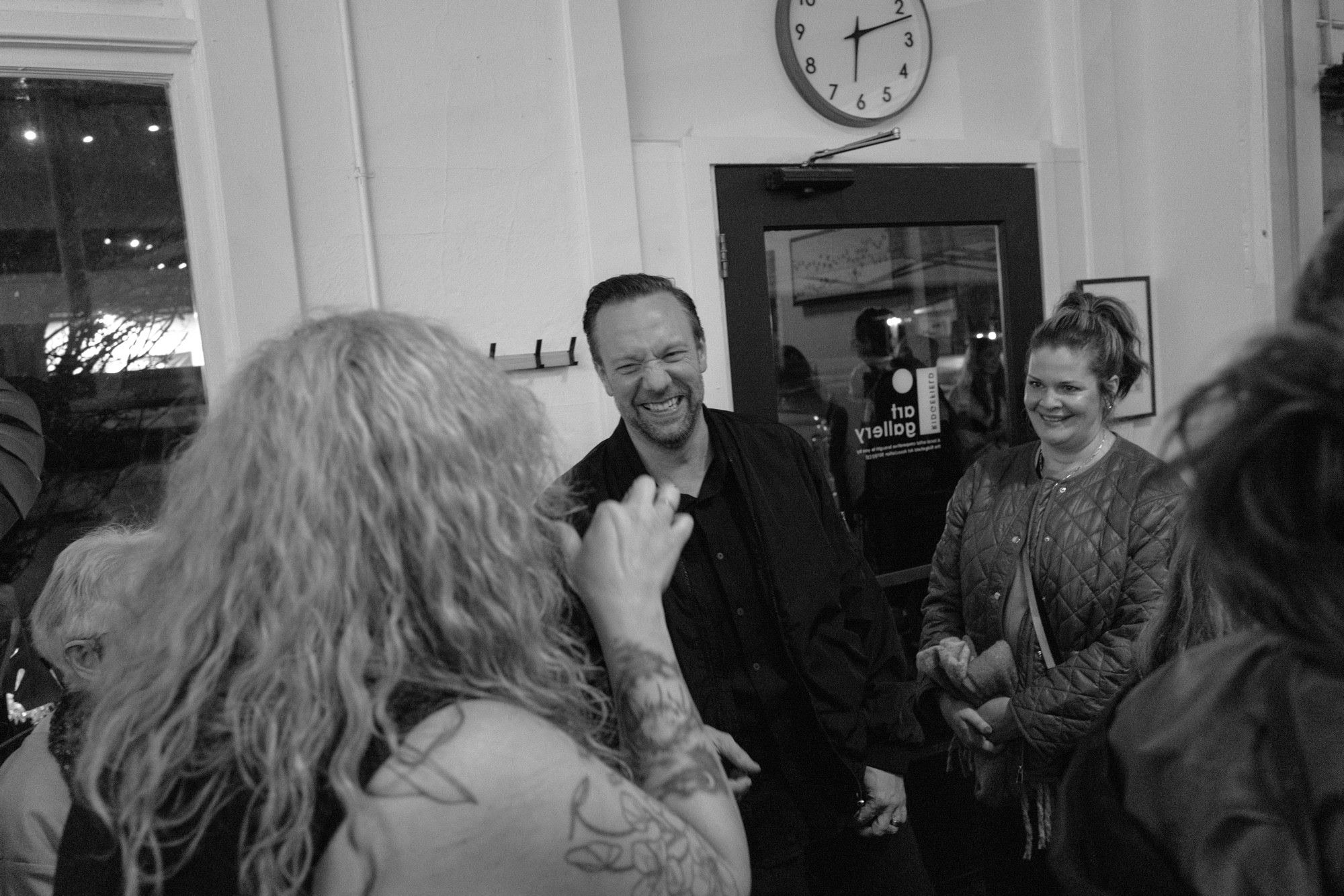 Ridgefield Mayor Matt Cole laughs with gallery visitors. 